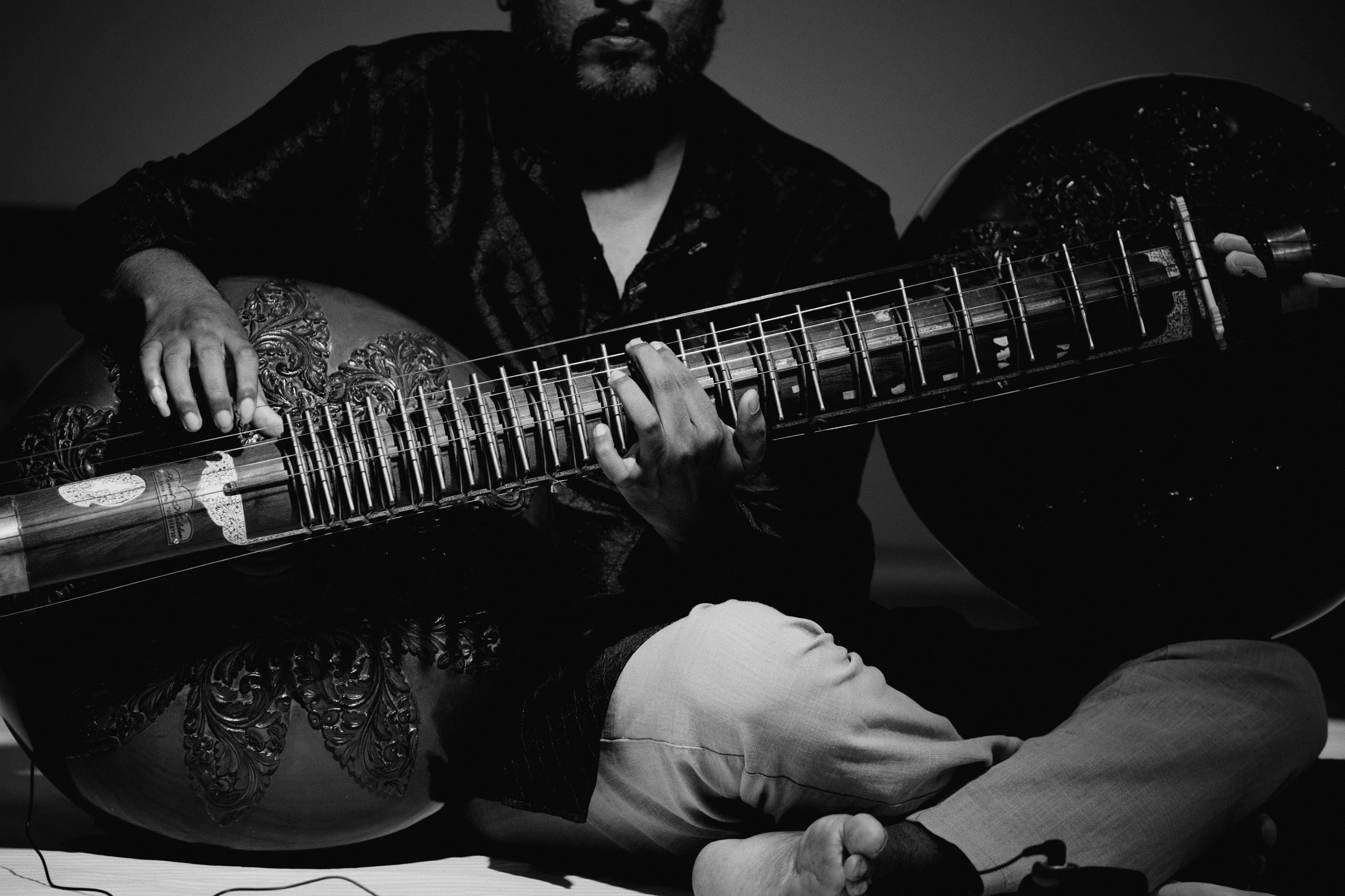 A rudra veena (the been) in performance, with its two gourds and fretted neck. It's the deepest voice of the dhrupad tradition, with a slow, heavy note allowed to fully dwell.