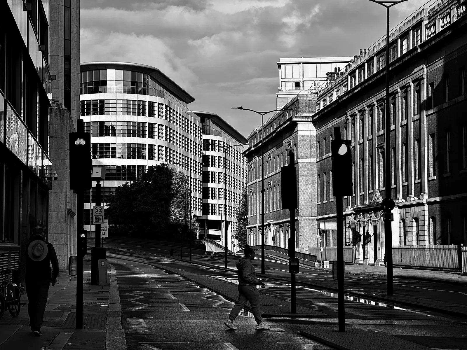 Lower Thames Street in the City in the evening light, almost empty, with one person crossing