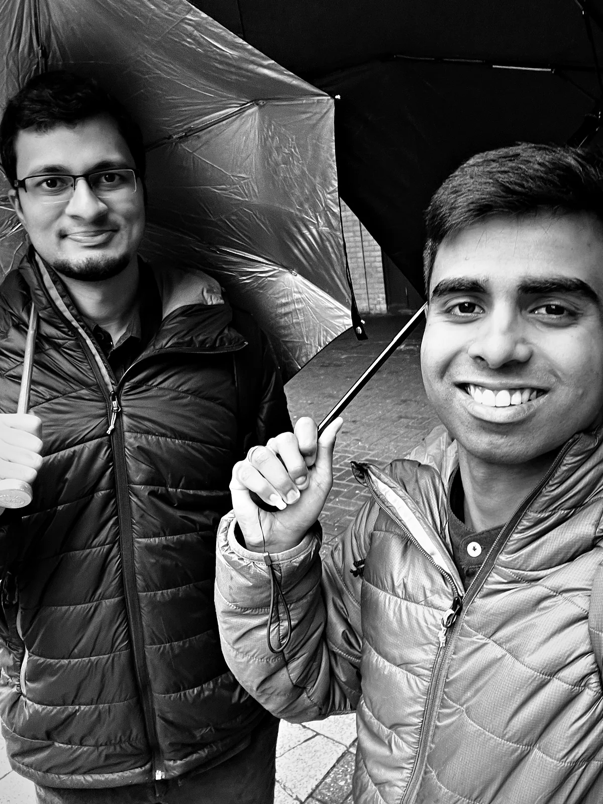 Viren and me under umbrellas on a wet morning in Paddington