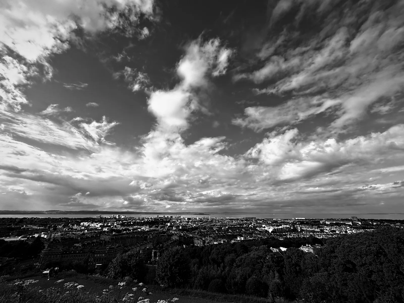 Edinburgh running down to Leith and the Firth of Forth from Calton Hill, under a big sky