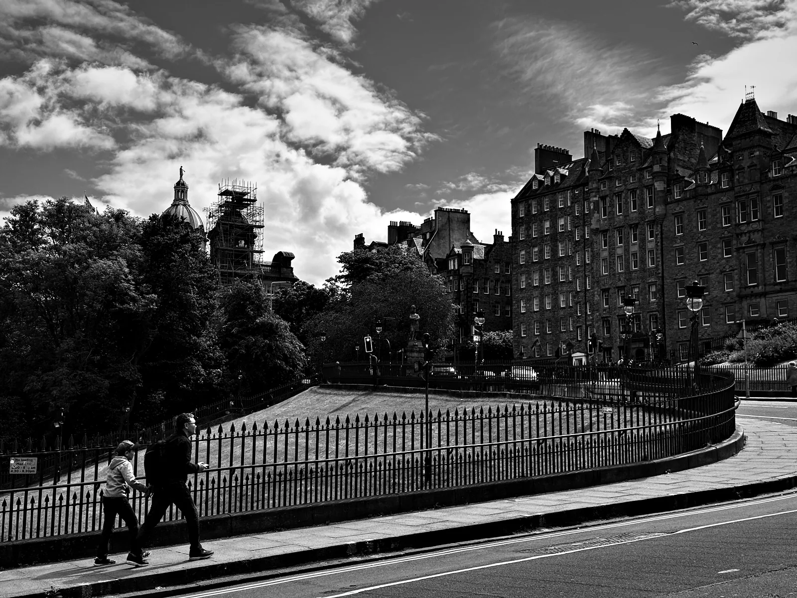 The Mound curving down beside Princes Street Gardens, with the Old Town's tenements above