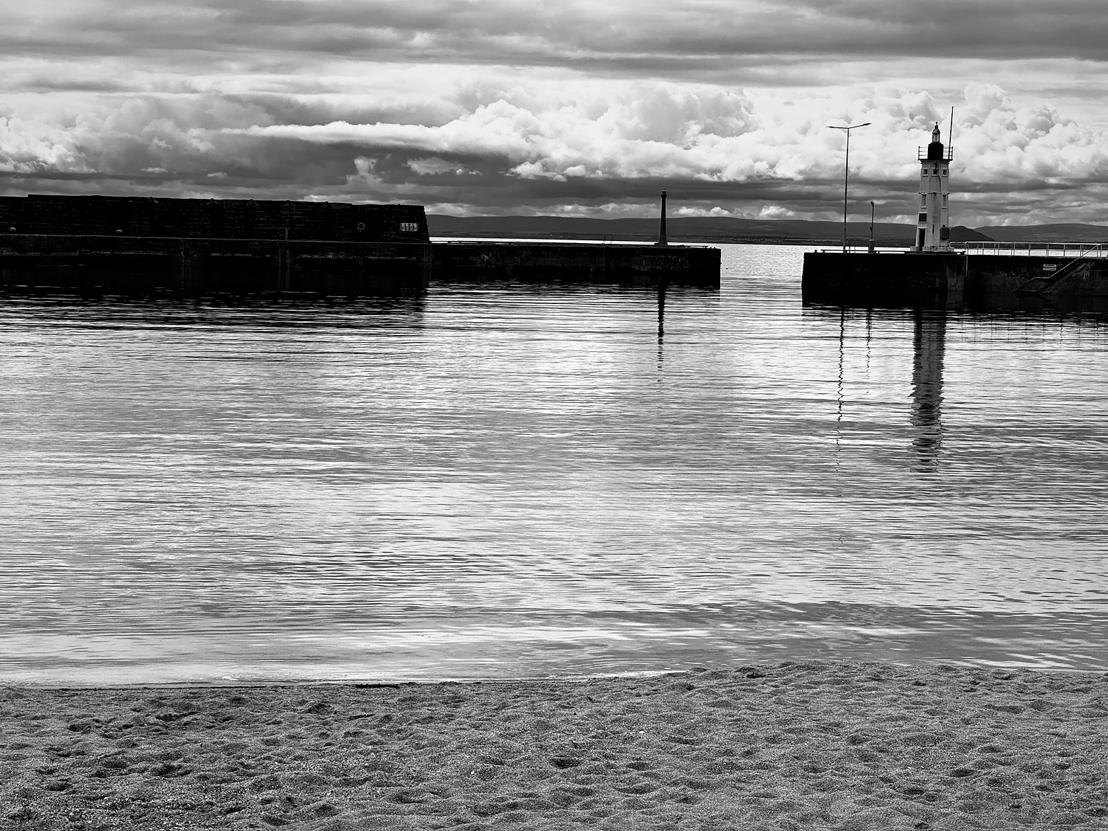 Anstruther harbour mouth and its small lighthouse over still water