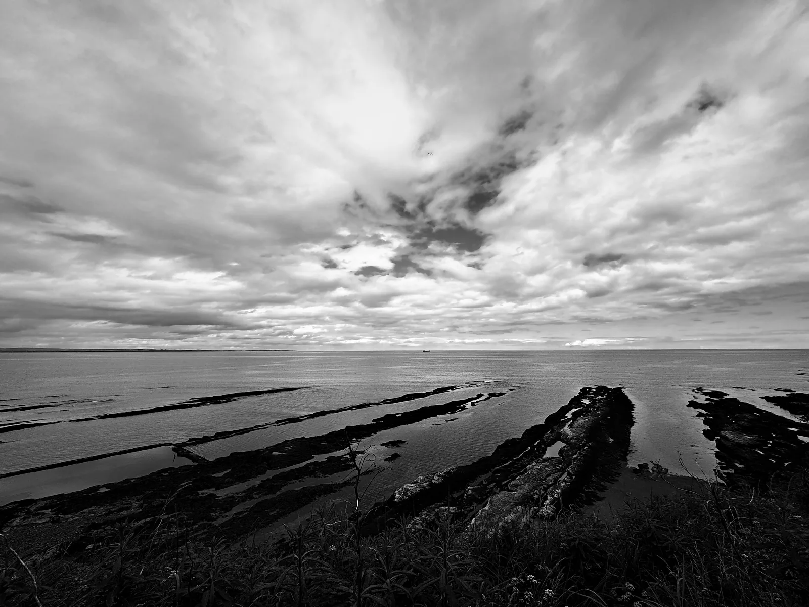 Flat rock ledges running out into the North Sea below St Andrews, under a big sky