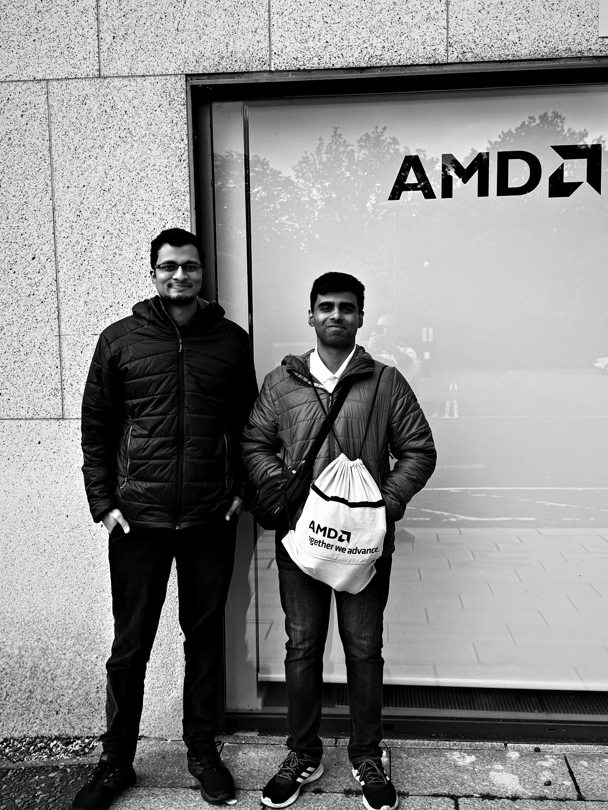 Viren and me under the AMD logo on the glass front of the office at Edinburgh Technopole