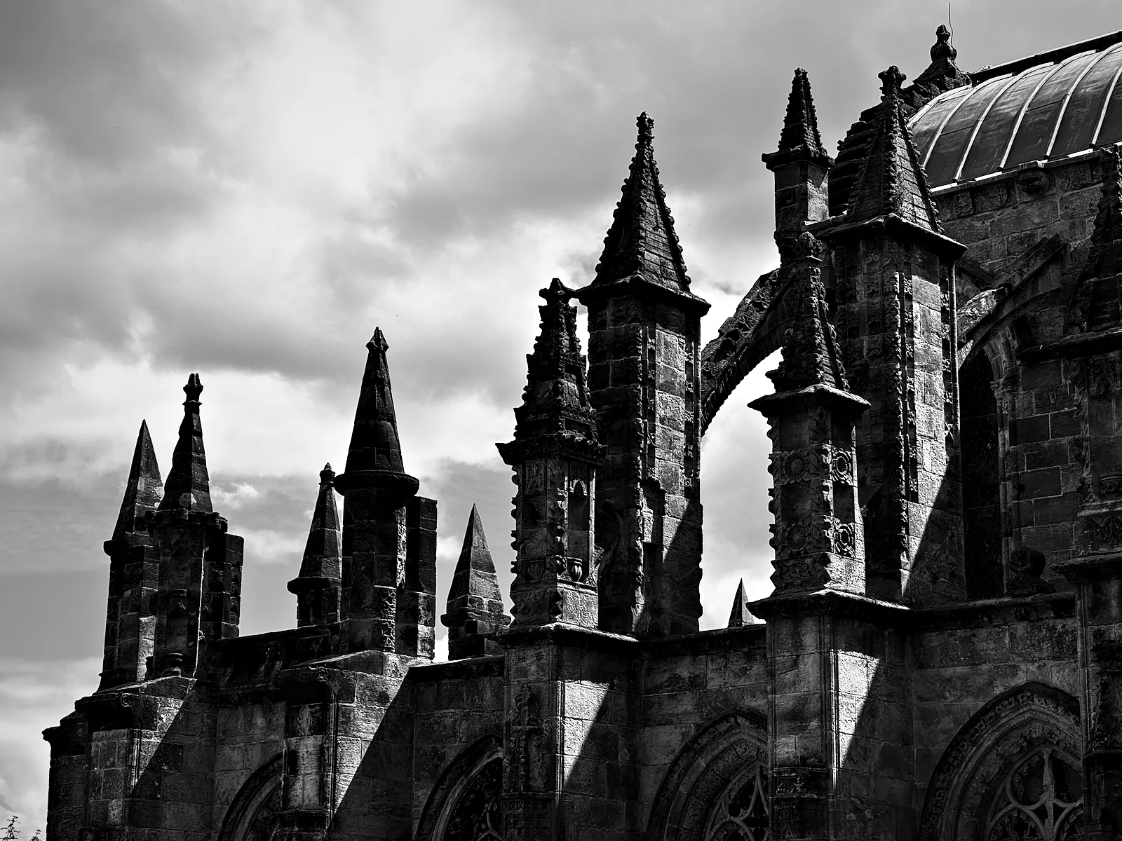 Rosslyn Chapel's pinnacles and flying buttresses against cloud