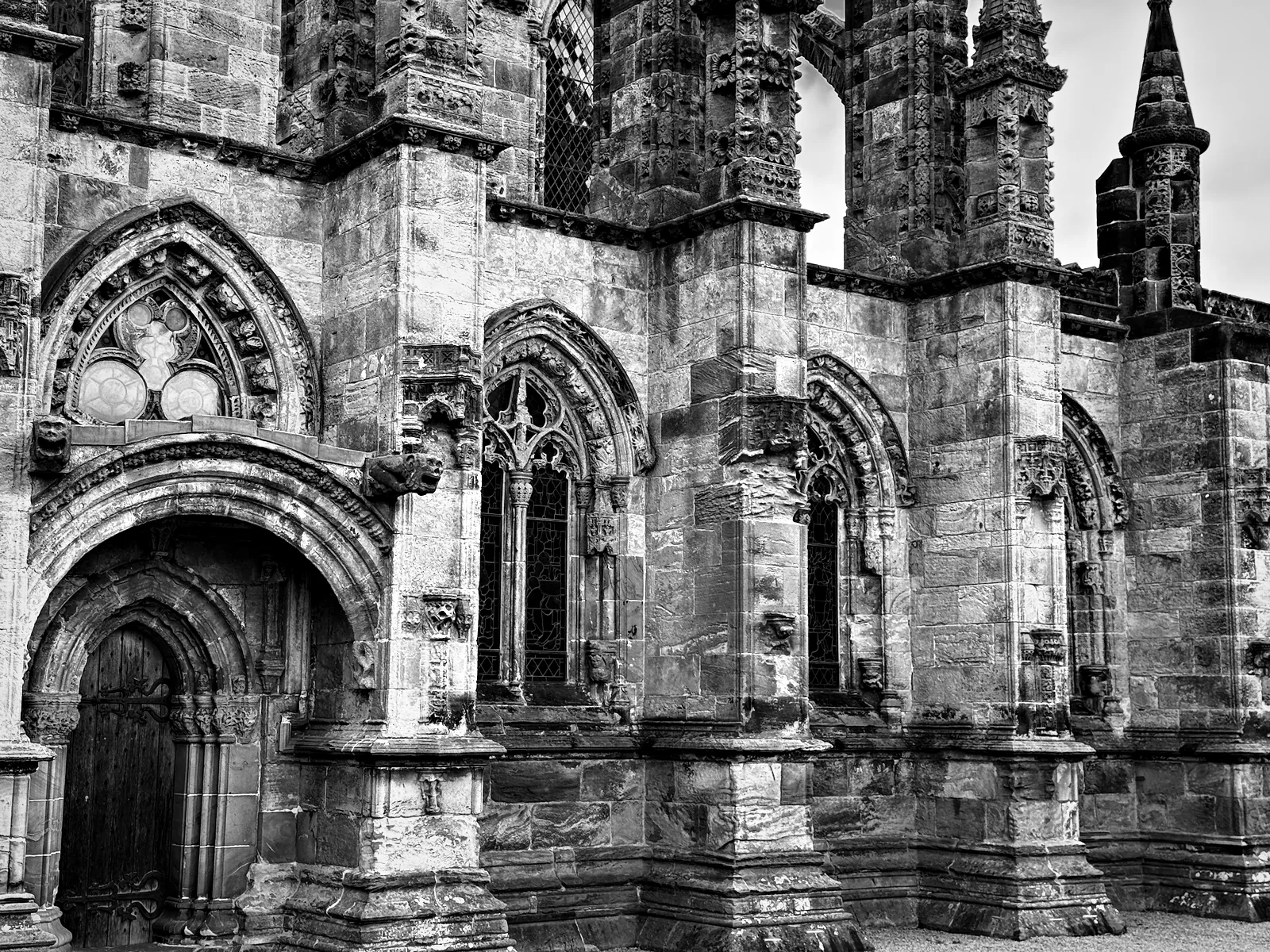 A carved doorway and window tracery on the outside of Rosslyn Chapel