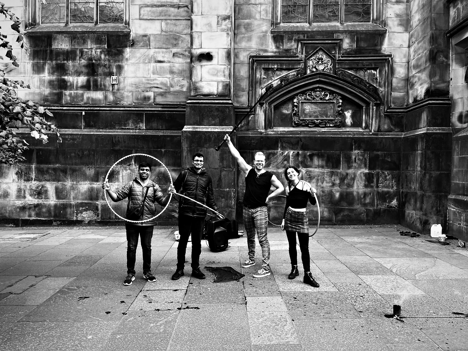 Viren and me holding hula hoops with two street circus performers beside St Giles' Cathedral on the Royal Mile