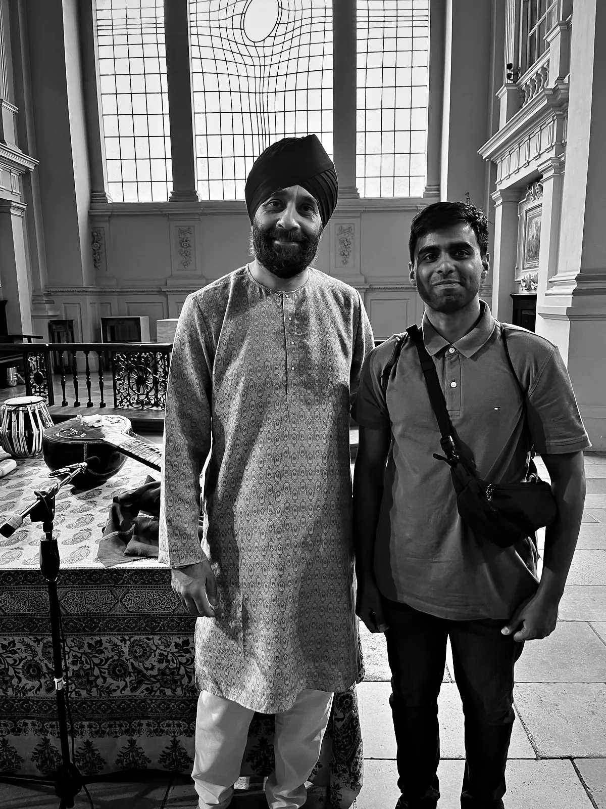 Me with Harmeet Virdee after the concert at St Martin-in-the-Fields, with the tabla and sitar still on the stage and the east window behind us