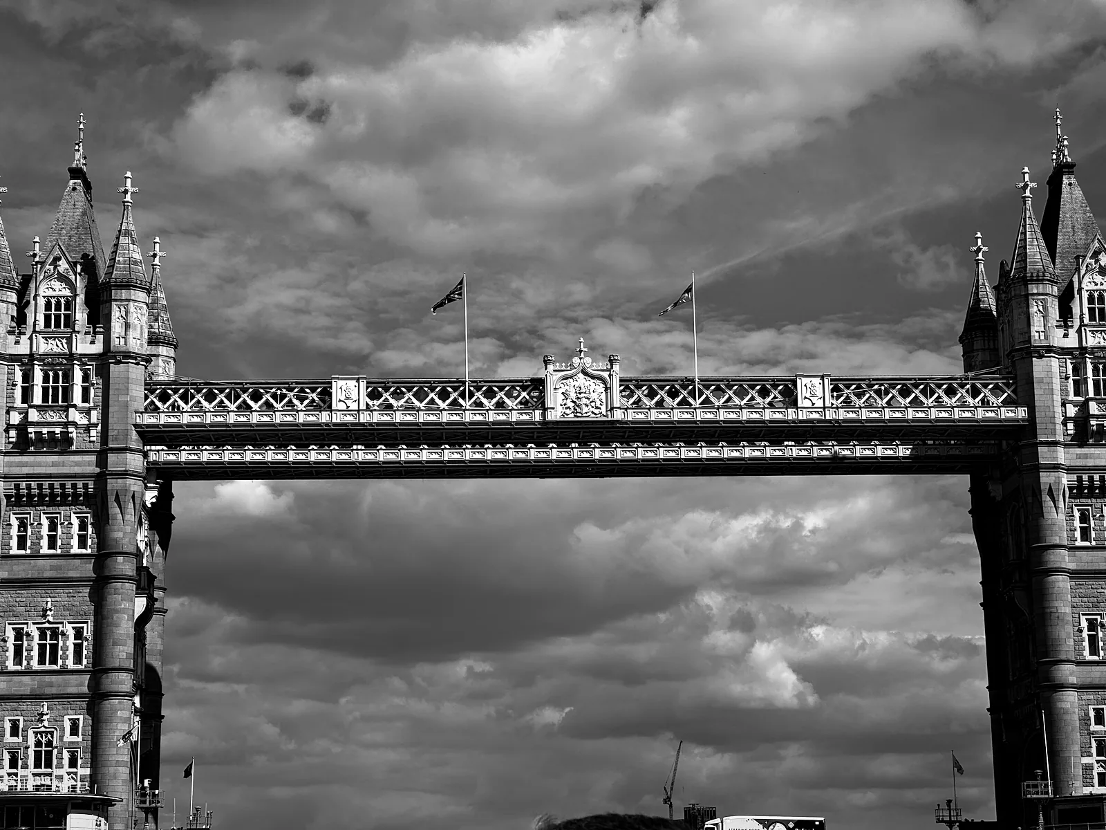 Tower Bridge's towers and high walkways seen from a boat on the Thames