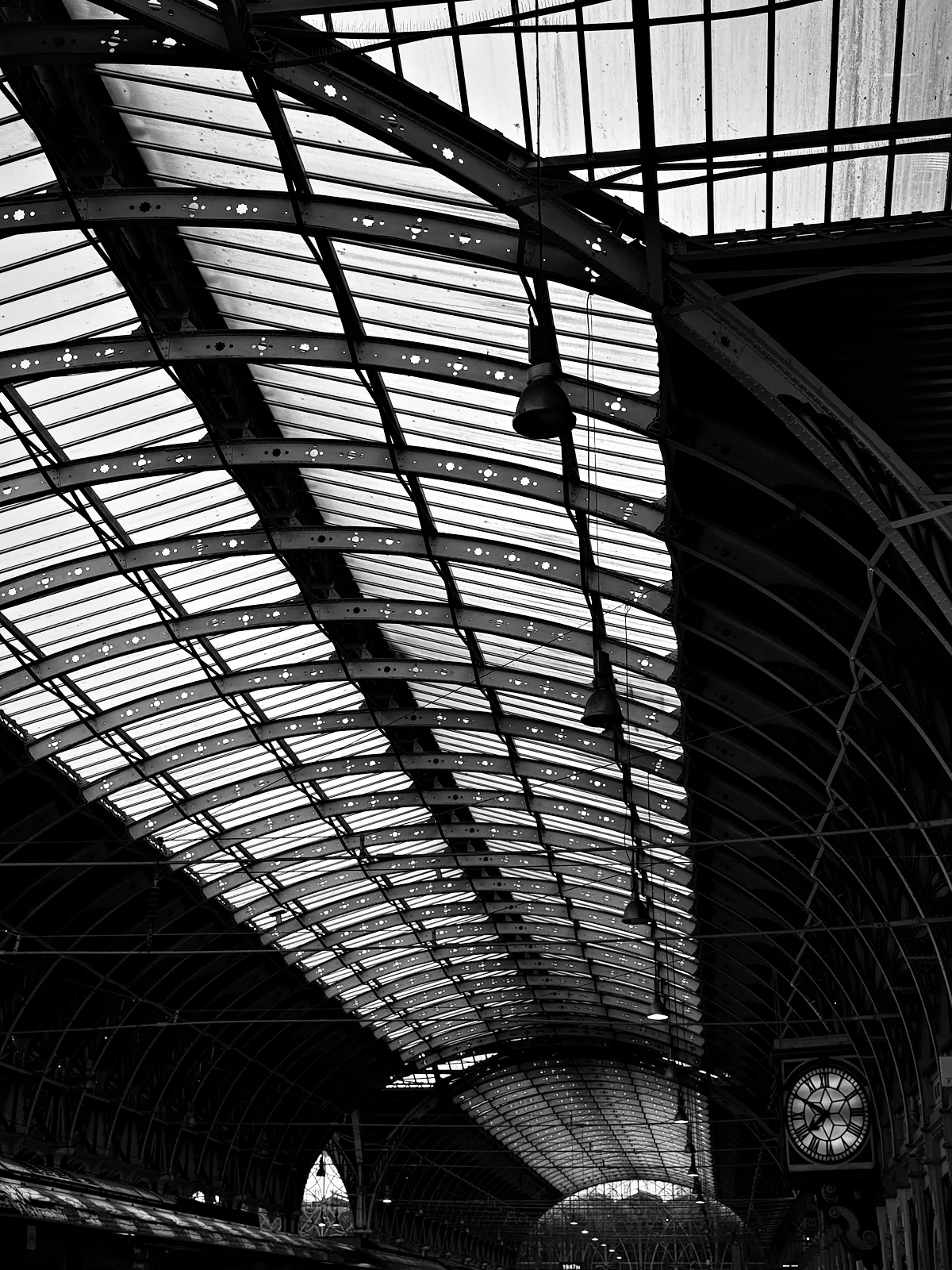 The iron roof ribs and clock inside Paddington station